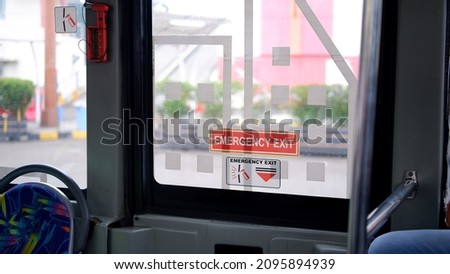 Emergency exit door with emergency hammer in public bus or public transportation