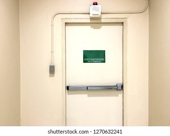 Emergency Exit Door With Siren Alarm In Store Building.