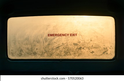 Emergency Exit Sign On A Misty Bus Rear Window