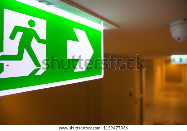 Emergency\
Fire exit sign at  the corridor in\
building