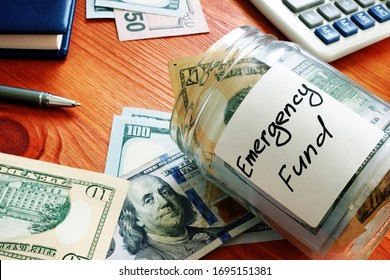 Emergency fund in the glass jar with cash. - Shutterstock ID 1695151381