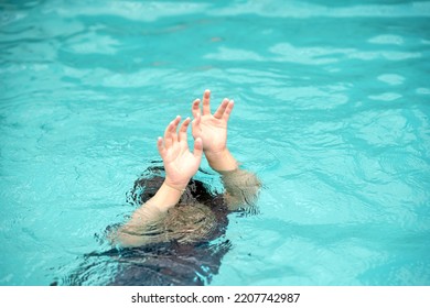 emergency kid drowing in swimming pool show up two hand call for help - Shutterstock ID 2207742987