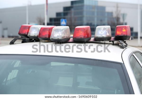 emergency lights on the roof of a police car. police\
flashing lights close\
up