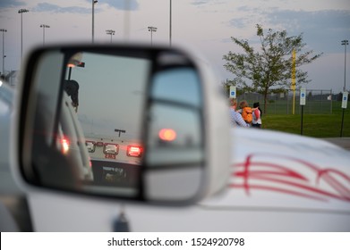 Emergency Lights Seen In Side Mirror Of Vehicle