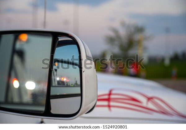 Emergency lights\
seen in side mirror of\
vehicle