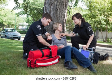 Emergency medical professionals assessing an injured patient on the street - Powered by Shutterstock