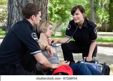 Emergency medical professionals assessing an injured patient - Powered by Shutterstock