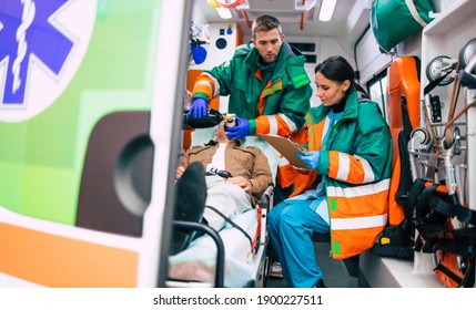 Emergency medical service team with senior patient in an ambulance