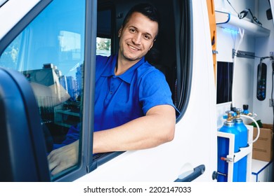 Emergency Medical Services Worker. Portrait Of Male Paramedic Sitting Inside Ambulance