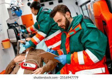 An emergency medical team is providing exceptional care to a patient in an ambulance, addressing critical, lifethreatening situations that demand immediate attention from healthcare professionals - Powered by Shutterstock