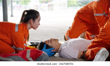 Emergency medical technician Asian woman (EMT) or paramedic team is holding manual stabilization of the head patients, Emergency medical services (EMS) nurses concept