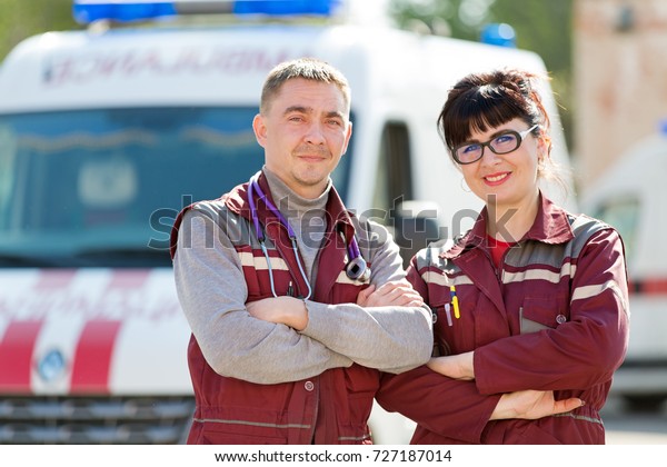 Emergency Medicine. Doctor with colleague\
paramedic on ambulance vehicle\
background
