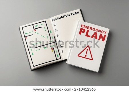 Emergency plan book with evacuation map and safety guidelines on a gray surface