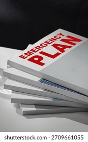 Emergency plan documents stacked on a desk for quick reference in crisis situations