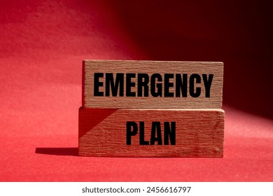 Emergency plan words written on wooden blocks with red background. Conceptual emergency plan symbol. Copy space.