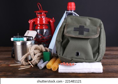 Emergency Preparation Equipment On Wooden Table, On Dark Background