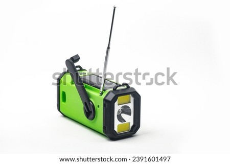 Emergency radio with flashlight rechargeable using built-in hand crank or solar cell