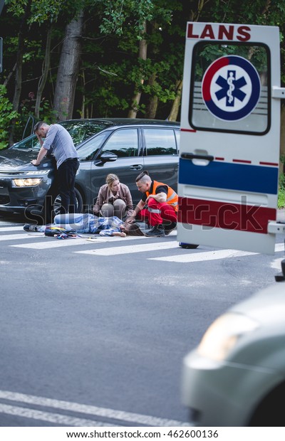 Emergency rescuer giving the first aid to the\
victim of an accident