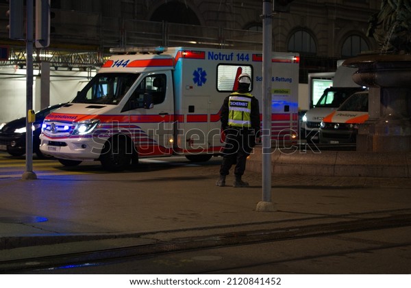 Emergency response with ambulance\
van and police van at Zürich main railway station on an early\
winter morning. Photo taken February 9th, 2022, Zurich,\
Switzerland.