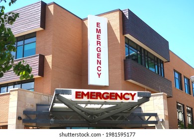 Emergency Room Entrance At A Hospital. Sign And Brick Exterior On A Sunny Day.                               
