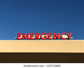 Emergency Room ER Entrance Sign Above Door Outside, Copy Space On Sky.