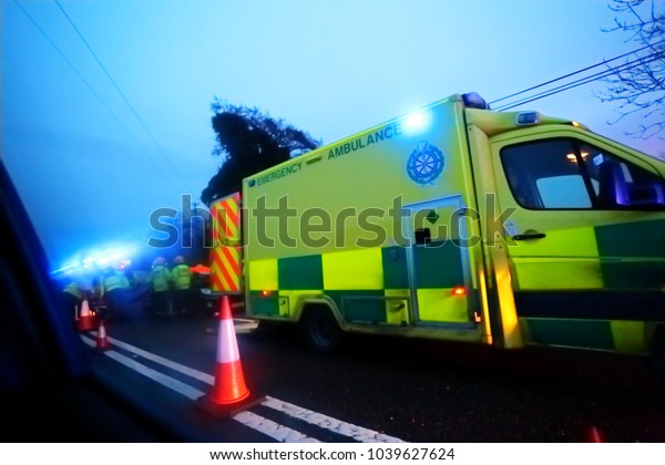 Emergency services (ambulance and\
firefighters ) at the scene of a road traffic\
accident