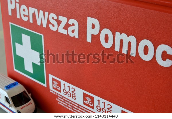 Emergency services and an inscription in Polish:\
first aid
