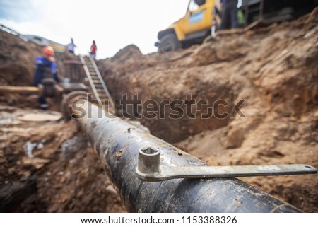 emergency services, the repair team provides safety during the replacement of pipes, old communications are changed to new ones, the gas pipeline, the old and rusted water pipe with dirty gates, repla