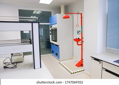 Emergency shower and emergency eye wash in laboratory science classroom interior of university college. Shelf cabinet furniture in medical and clinical laboratories room.