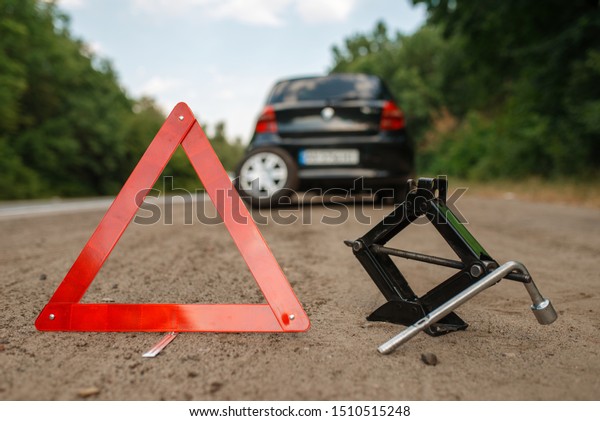 Emergency stop\
sign, car breakdown, punctured\
tire