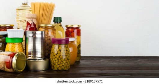 Emergency Survival Food Set On Dark Wooden Kitchen Table