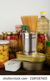 Emergency Survival Food Set On Dark Wooden Kitchen Table