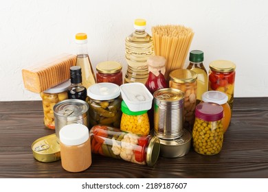 Emergency Survival Food Set On Dark Wooden Kitchen Table