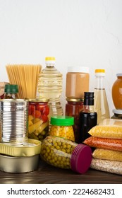 Emergency Survival Food Set On Dark Wooden Kitchen Table