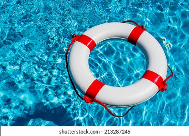 an emergency tire floating in a swimming pool. symbol photo for rescue and crisis management in the financial crisis and banking crisis.