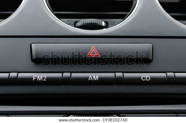 emergency triangle\
button on black car\
dashboard