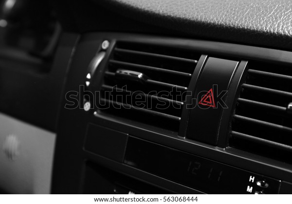 Emergency warning\
button on car console,\
closeup