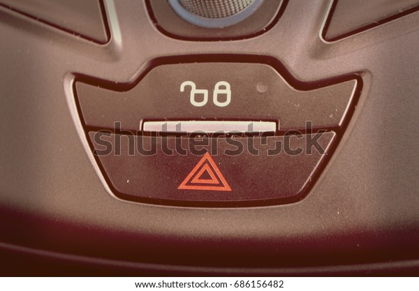 Emergency warning\
button on car console,\
closeup
