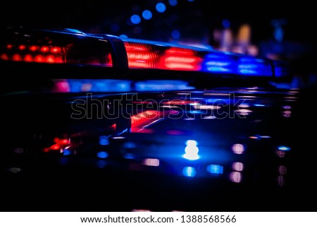 Emergency warning red and blue roof mounted police LED blinker light bar turned on