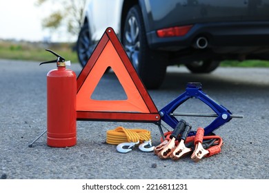 Emergency warning triangle and car safety equipment outdoors - Shutterstock ID 2216811231