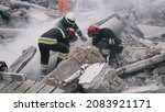 Emergency workers removing rubble together
