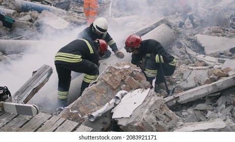 Emergency workers removing rubble together