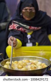 Emirate Lady Cooking Luqaimat Sweet In Sweehan Heritage Festival February 13, 2015 In Abu Dhabi, United Arab Emirates