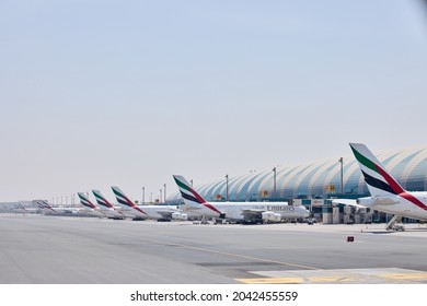 Emirates Airline planes in a row being prepared to fly. Dubai International Airport terminal 3 busy during EXPO 2020-2021 season- Dubai, UAE - Sep 2021