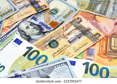 Emirates Dirhams money with American dollars bills and European euros banknotes, a pile of 200 two hundred Emirates Dirhams, 100 one hundred dollars and 100 one hundred euros exchange rate