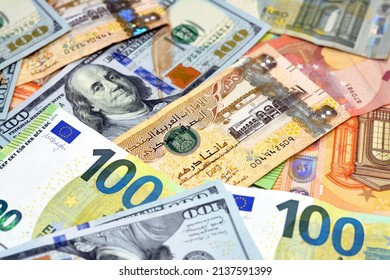 Emirates Dirhams money with American dollars bills and European euros banknotes, a pile of 200 two hundred Emirates Dirhams, 100 one hundred dollars and 100 one hundred euros exchange rate