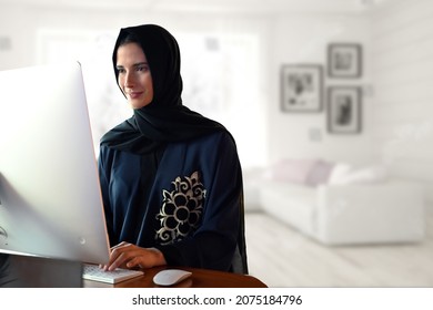 Emirati Arab Working From Home. Abaya Hijab On Middle East Woman While Using Computer Desktop Screen.