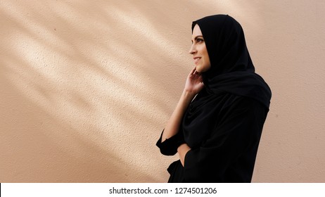 Emirati Arabic woman smiling in side view beauty look  with no filters and color grade