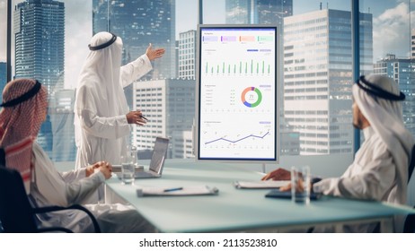 Emirati Businessman Holds Meeting Presentation For A Business Partners. Arab Manager Uses Digital Whiteboard With Growth Analysis, Charts, Statistics And Data. Saudi, Emirati, Arab Office Concept.