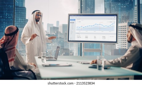 Emirati Businessman Holds Meeting Presentation For International Business Partners. Manager Uses Whiteboard With Growth Analysis, Charts, Statistics And Data. Saudi, Emirati, Arab Office Concept.